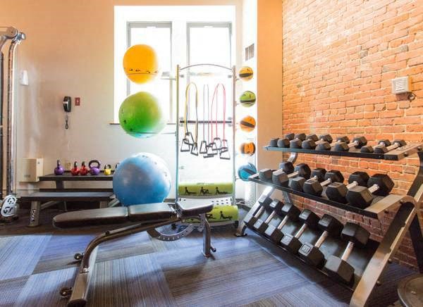 a gym with a bunch of weights on a rack